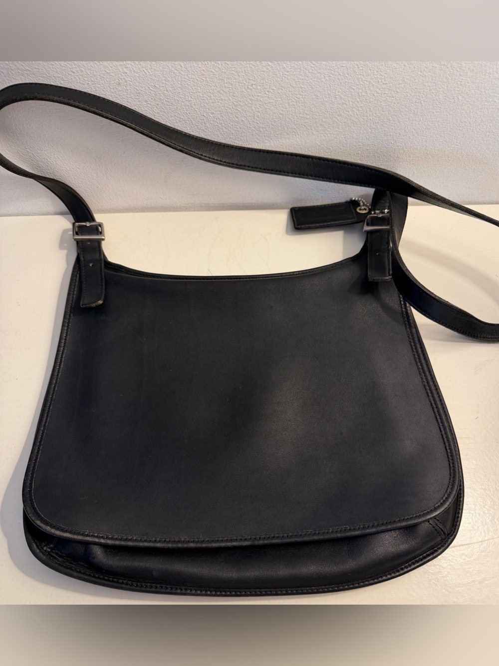 Coach vintage 9174 “Slim Hippie” black leather messenger style flap over bag.